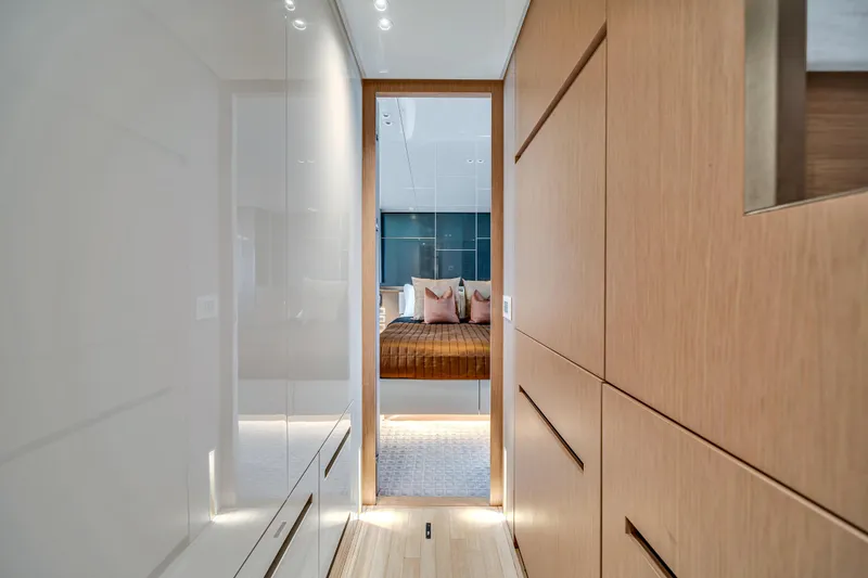Slide: The Image of Luxurious interior of 2020 Sanlorenzo SX88 yacht, featuring modern wood paneling and elegant bedroom. - 86