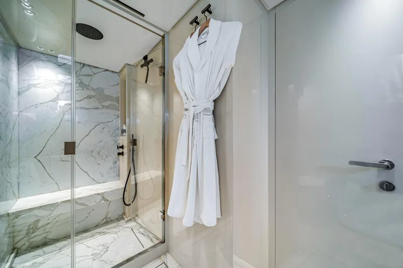 Slide: The Image of Luxurious marble bathroom with shower and robe on Sanlorenzo SX88 yacht, 2020 model. - 96