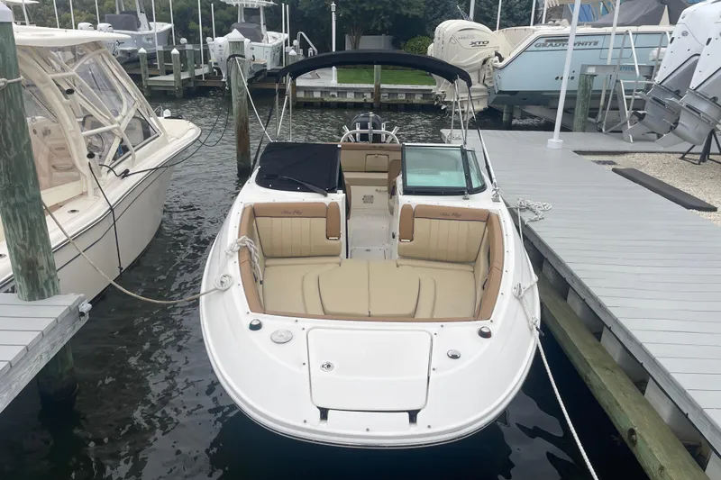 Slide: The Image of 2014 Sea Ray 240 Sundeck Outboard docked at marina, featuring spacious seating and canopy. - 0