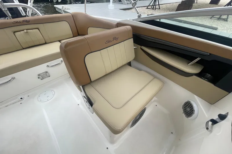 Slide: The Image of 2014 Sea Ray 240 Sundeck Outboard interior with beige seating and sleek design. - 10