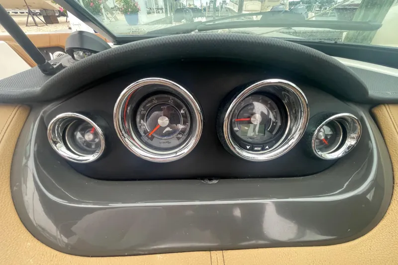 Slide: The Image of Dashboard of a 2014 Sea Ray 240 Sundeck Outboard boat with gauges and controls. - 7
