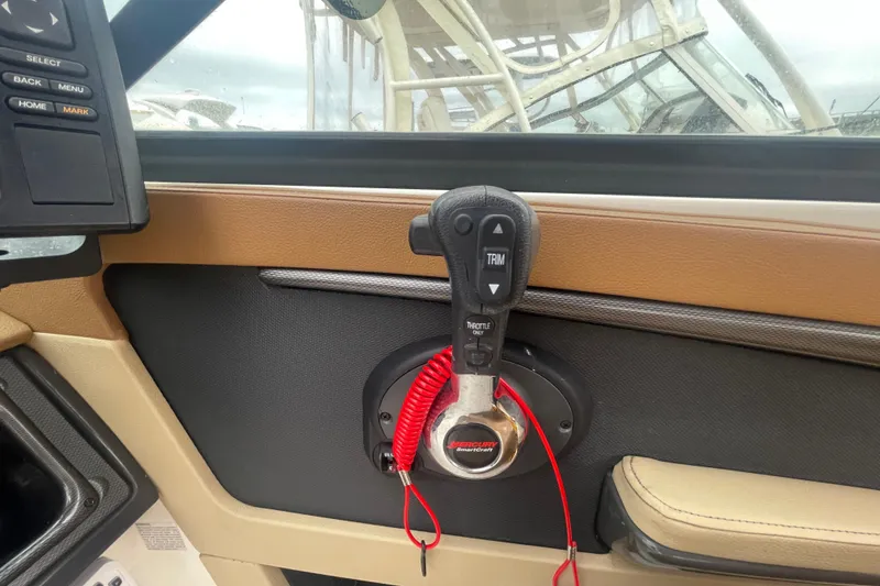 Slide: The Image of Throttle control of 2014 Sea Ray 240 Sundeck Outboard boat with trim buttons. - 8