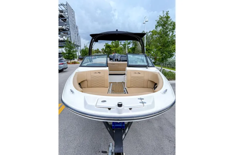 Slide: The Image of 2023 Sea Ray 19 SPX OB boat with tan seating, parked outdoors. - 6