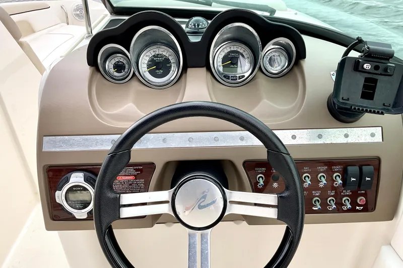 Slide: The Image of Steering console of 2013 Sea Ray 280 Sundeck with gauges and controls. - 10