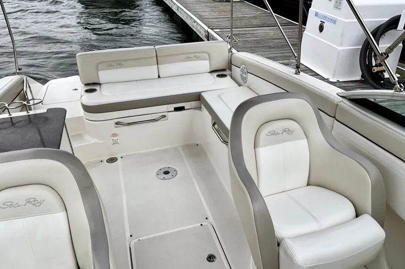 Slide: The Image of 2013 Sea Ray 280 Sundeck interior with white seating and sleek design. - 14