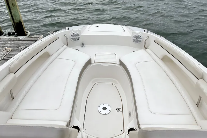 Slide: The Image of 2013 Sea Ray 280 Sundeck boat interior with white seating and open water view. - 5