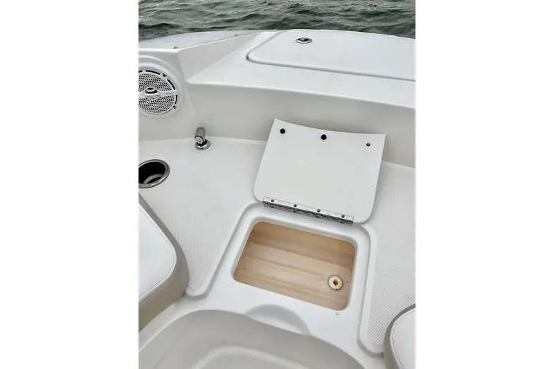 Slide: The Image of 2013 Sea Ray 280 Sundeck interior with storage compartment and speaker. - 8