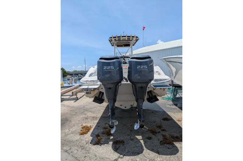 Slide: The Image of 2004 Wellcraft 29 CCF boat with twin 225 horsepower engines, docked outdoors. - 3