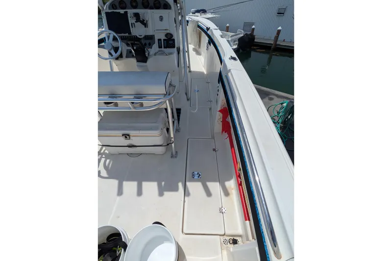 Slide: The Image of 2004 Wellcraft 29 CCF boat interior with steering console and seating area. - 4