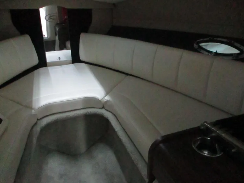 Slide: The Image of Interior cabin of 2018 Rinker QX29 CC boat with seating and door. - 10