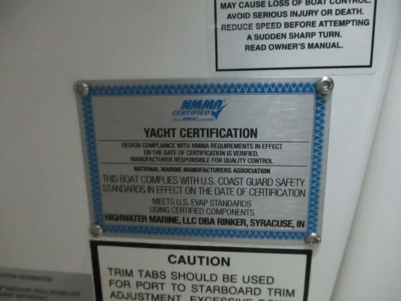 Slide: The Image of 2018 Rinker QX29 CC boat interior with cushioned seating and walkway. - 13