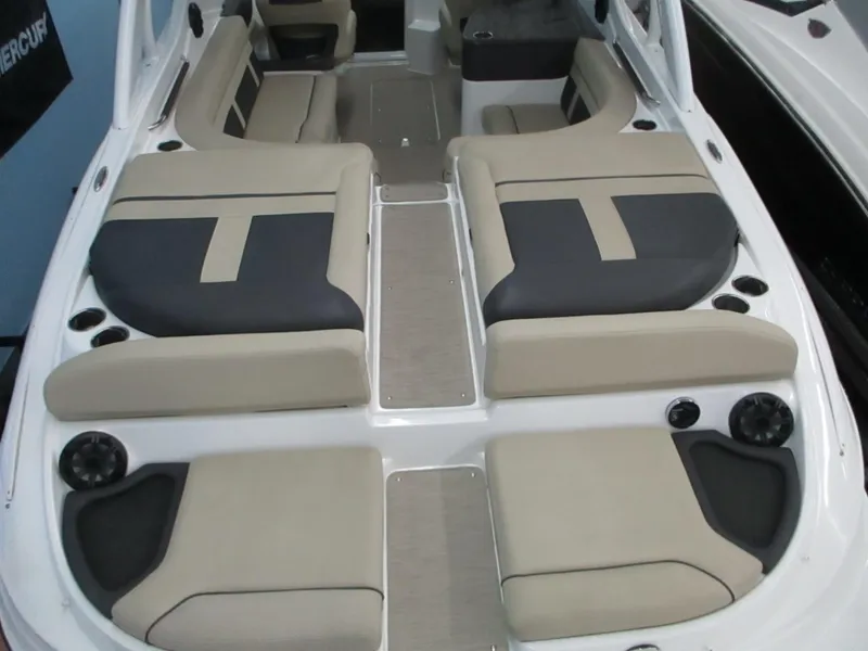Slide: The Image of 2018 Rinker QX29 CC boat interior with spacious seating and modern dashboard. - 2