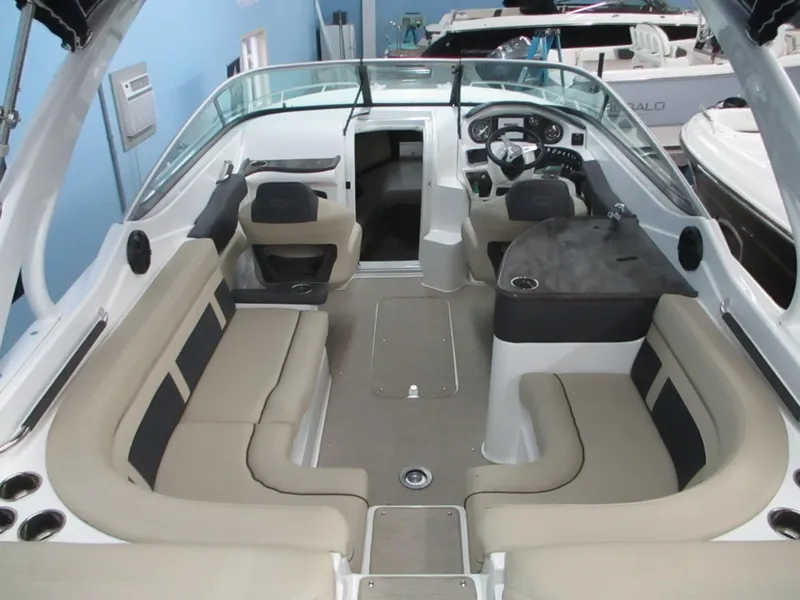 Slide: The Image of 2018 Rinker QX29 CC boat interior with seating, steering wheel, and dashboard. - 3