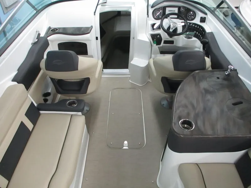 Slide: The Image of 2018 Rinker QX29 CC boat interior with sink and cup holder. - 4