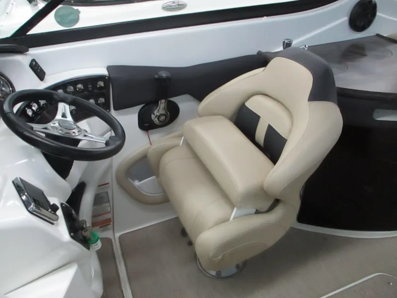 Slide: The Image of 2018 Rinker QX29 CC boat interior with beige seating and modern design. - 7