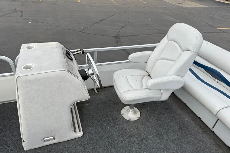 Slide: The Image of 1989 Riviera Cruiser Fun Deck 22 interior with white captain's chair and steering console. - 10