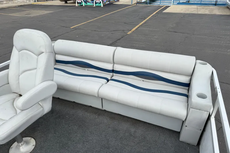 Slide: The Image of 1989 Riviera Cruiser Fun Deck 22 interior with white seating and blue accents. - 11