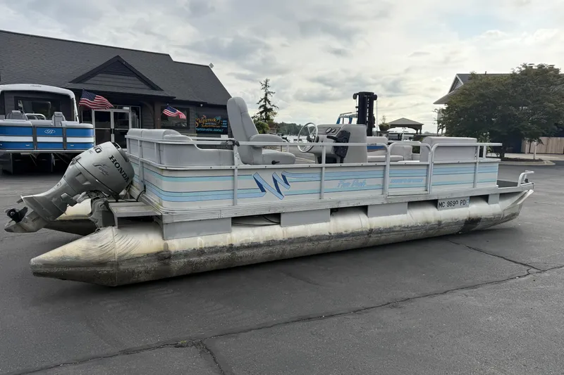 Slide: The Image of 1989 Riviera Cruiser Fun Deck 22 pontoon boat with Honda outboard motor on display. - 4