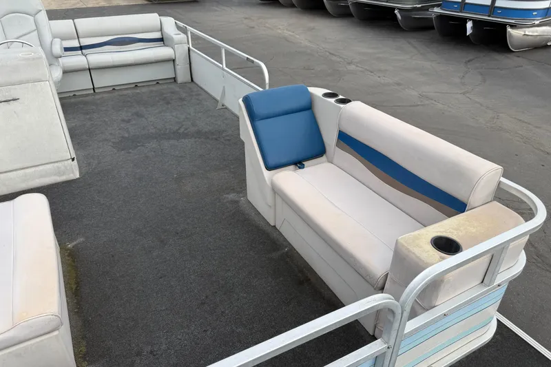 Slide: The Image of 1989 Riviera Cruiser Fun Deck 22 interior with blue and white seating, cup holders, and spacious layout. - 8