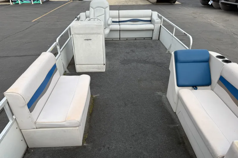 Slide: The Image of 1989 Riviera Cruiser Fun Deck 22 pontoon boat interior with seating and steering console. - 9