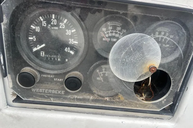 Slide: The Image of Hinckley Pilot 35 Sloop 1964 dashboard with Westerbeke engine gauges and controls. - 13