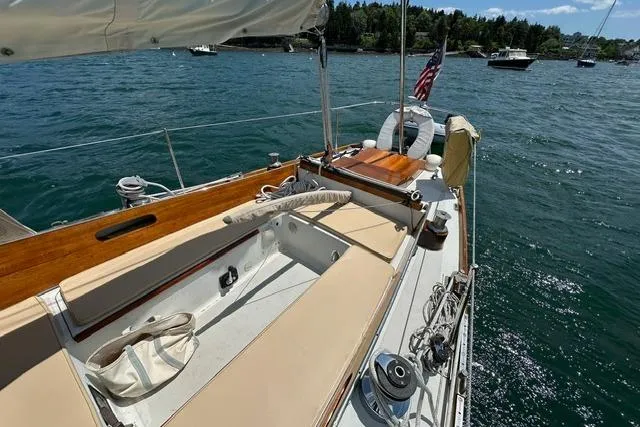 Slide: The Image of Hinckley Pilot 35 Sloop, 1964, sailing on a sunny day with scenic water views. - 19