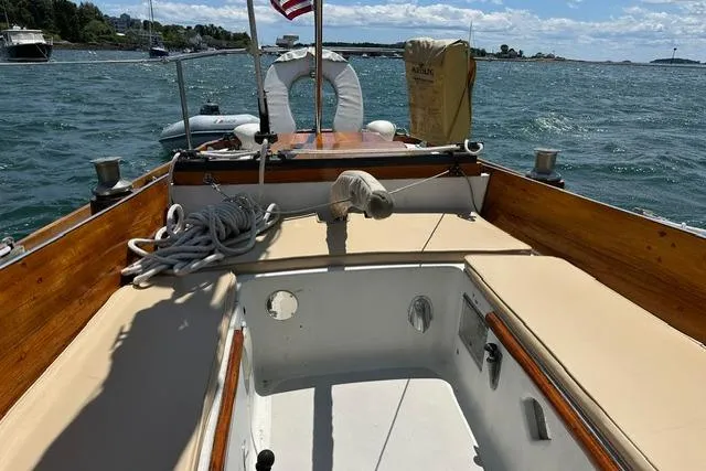 Slide: The Image of 1964 Hinckley Pilot 35 Sloop cockpit with wooden trim, moored on a sunny day. - 25