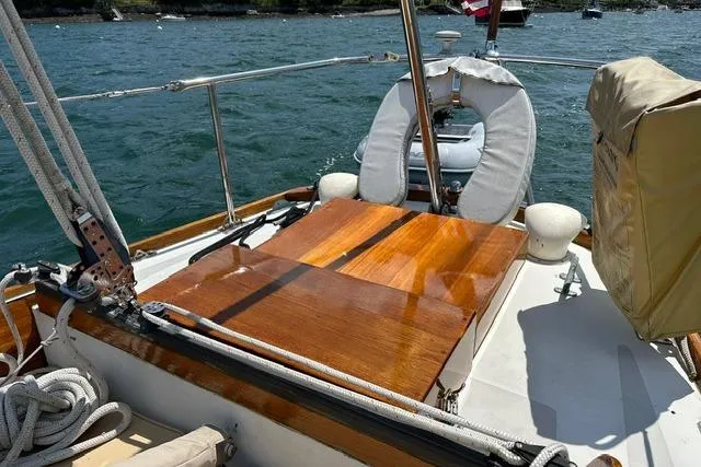 Slide: The Image of 1964 Hinckley Pilot 35 Sloop with polished wooden deck and nautical ropes. - 26