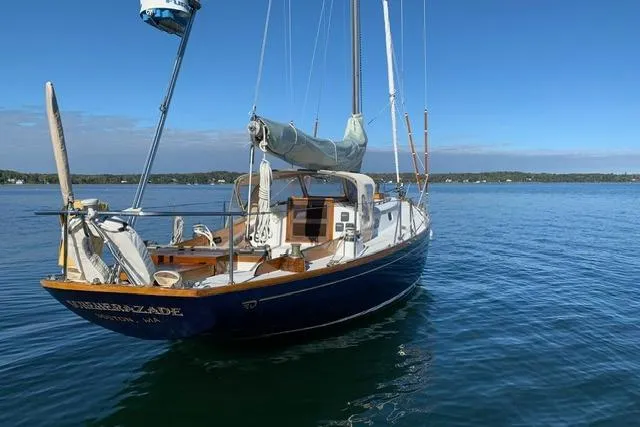Slide: The Image of 1964 Hinckley Pilot 35 Sloop sailing on calm waters under clear blue skies. - 35