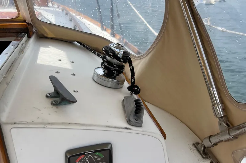 Slide: The Image of Hinckley Pilot 35 Sloop 1964 cockpit with winch, cleat, and navigation instruments. - 28