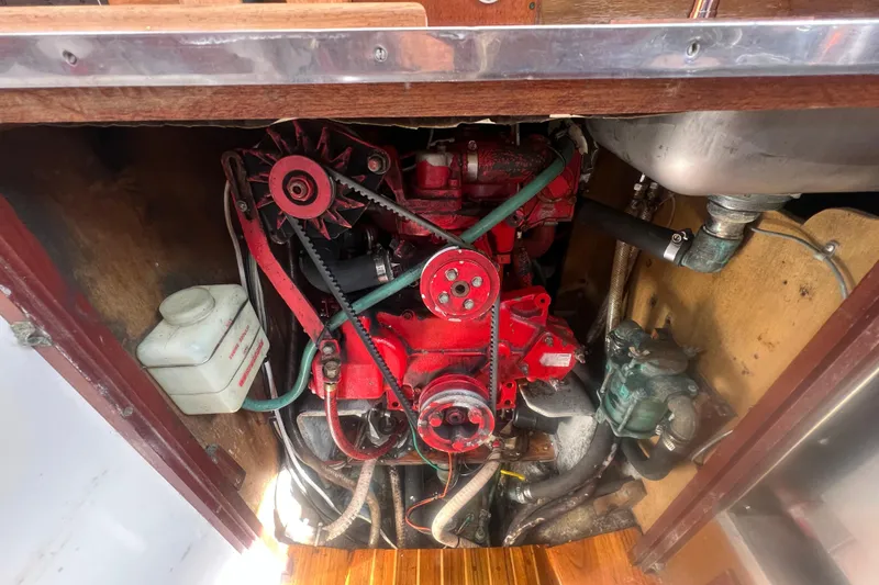 Slide: The Image of Engine compartment of a 1964 Hinckley Pilot 35 Sloop, featuring a red engine. - 29