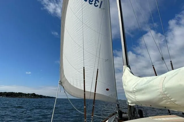 Slide: The Image of Sailing on a 1964 Hinckley Pilot 35 Sloop under clear blue skies. - 32