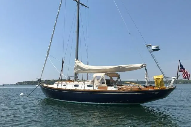Slide: The Image of 1964 Hinckley Pilot 35 Sloop sailboat on calm water, clear sky background. - 36