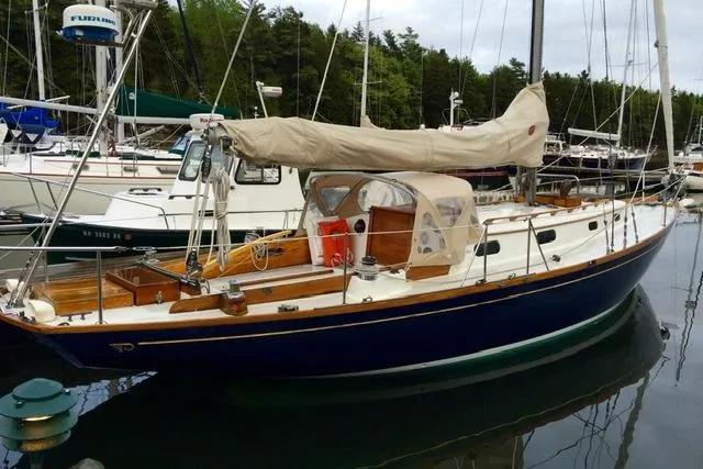 Slide: The Image of 1964 Hinckley Pilot 35 Sloop docked, featuring classic design and elegant wooden details. - 39
