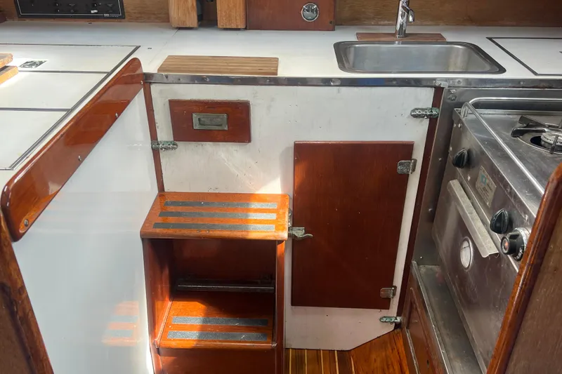 Slide: The Image of Interior of 1964 Hinckley Pilot 35 Sloop, featuring compact kitchen area. - 5