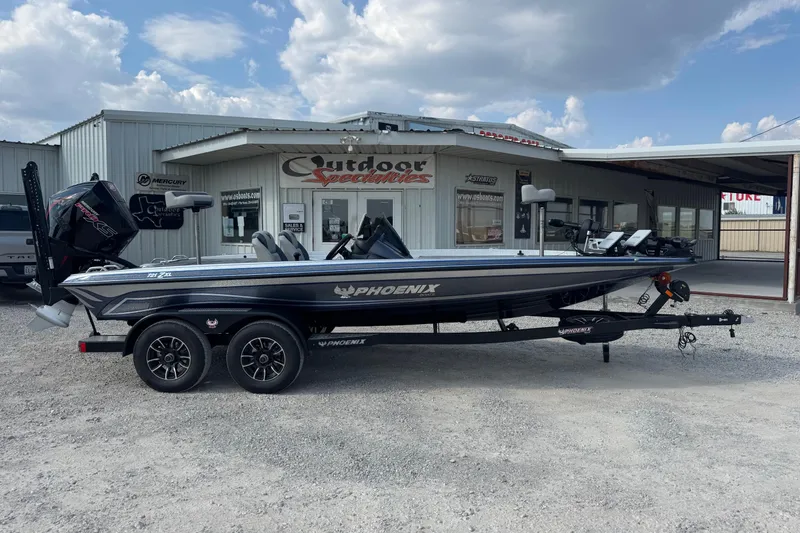 The Image of 2026 Phoenix 721 ZXL boat on trailer outside dealership under cloudy sky. - 1