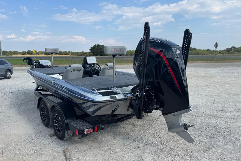 Slide: The Image of 2026 Phoenix 721 ZXL boat with dual motors on a gravel lot. - 3