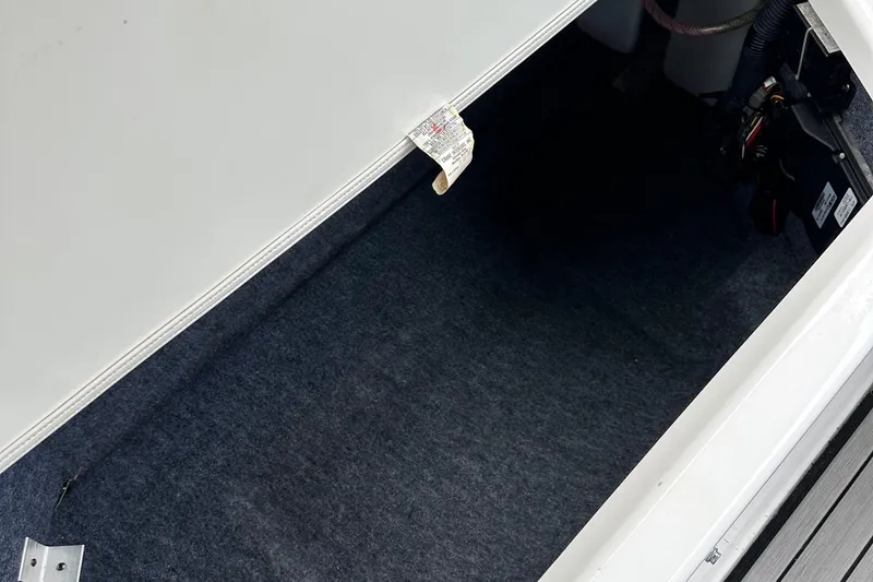 Slide: The Image of Storage compartment of 2018 Yamaha Boats 242 Limited S E-Series, featuring carpeted interior. - 13