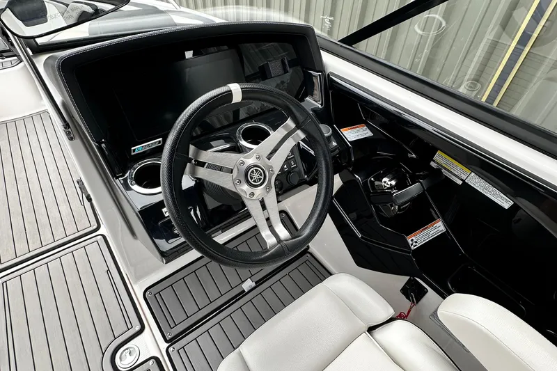 Slide: The Image of 2018 Yamaha Boats 242 Limited S E-Series dashboard with steering wheel and controls. - 5