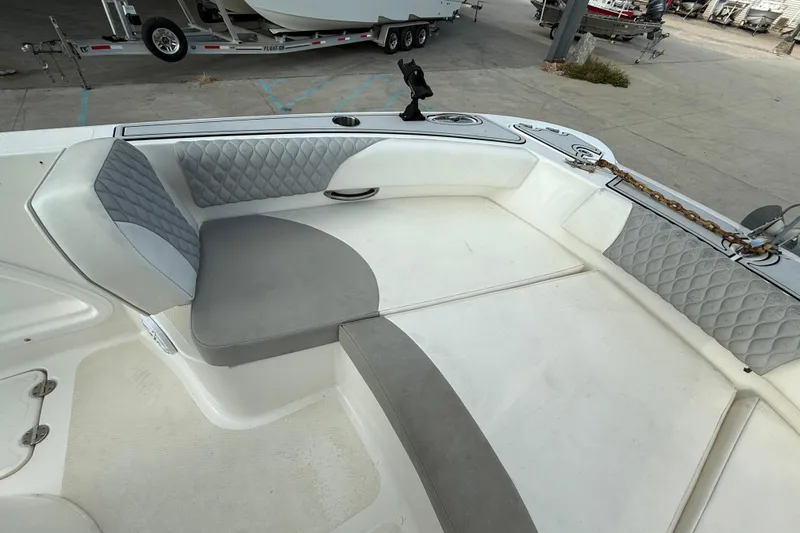 Slide: The Image of 2020 Twin Vee 240 GFX CC boat interior with cushioned seating and storage. - 13