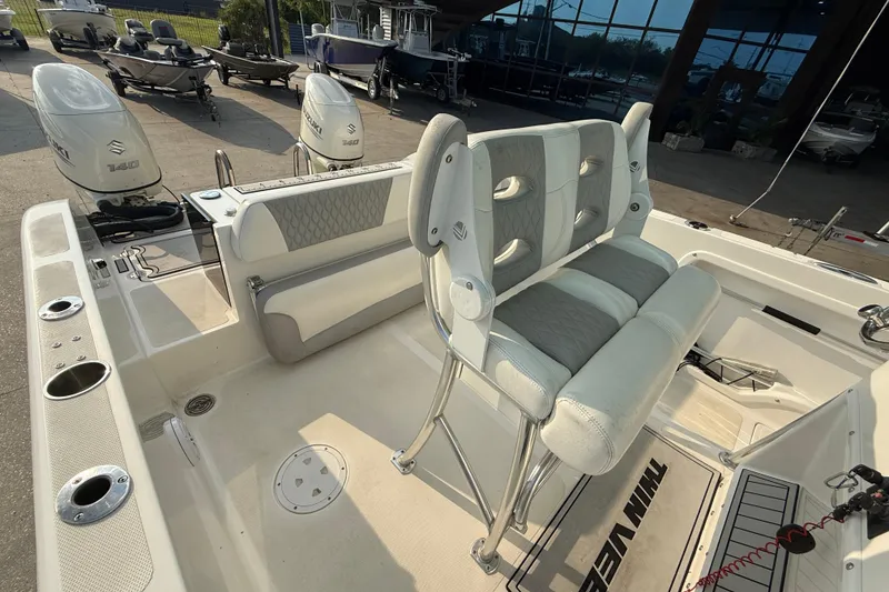 Slide: The Image of 2020 Twin Vee 240 GFX CC boat interior with dual Suzuki engines and cushioned seating. - 15