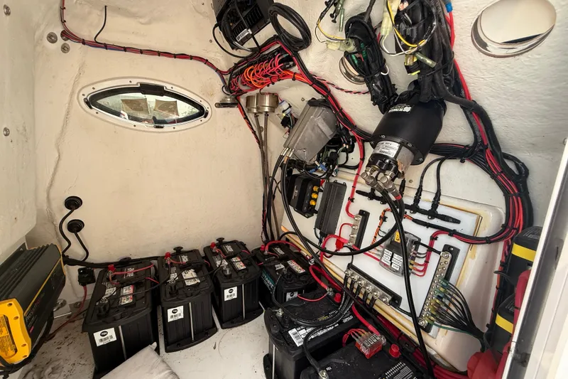Slide: The Image of Electrical system inside 2020 Twin Vee 240 GFX CC boat, featuring batteries and wiring. - 21