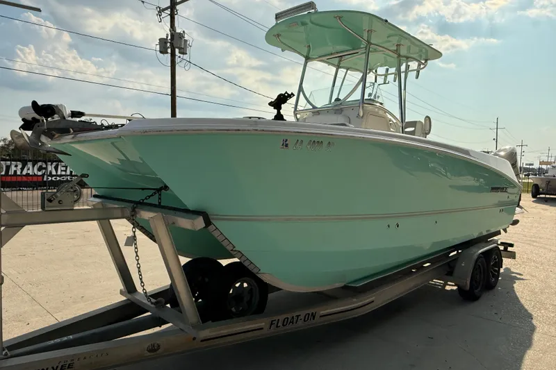 Slide: The Image of 2020 Twin Vee 240 GFX CC boat on trailer, light blue hull, sunny day. - 4