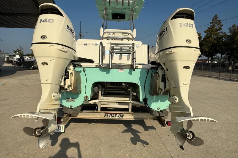 Slide: The Image of 2020 Twin Vee 240 GFX CC boat with dual Suzuki 140 outboard engines on a trailer. - 6