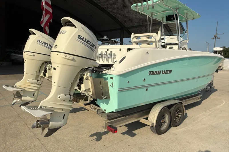 Slide: The Image of 2020 Twin Vee 240 GFX CC boat with dual Suzuki outboard engines on a trailer. - 7