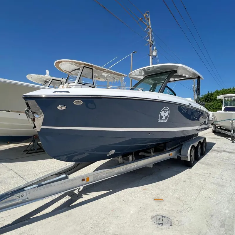 The Image of 2026 Monterey Elite 27 OB boat on trailer under clear blue sky. - 0