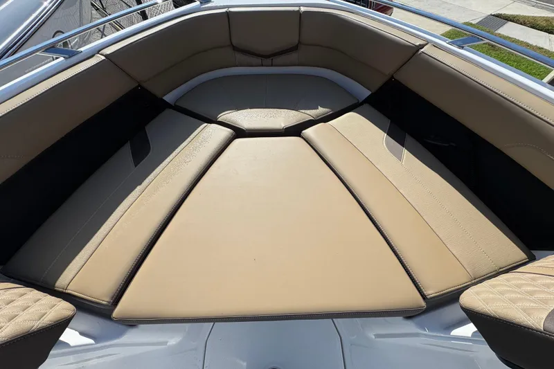 Slide: The Image of Luxurious seating area on 2026 Monterey Elite 27 OB boat, featuring tan upholstery. - 10
