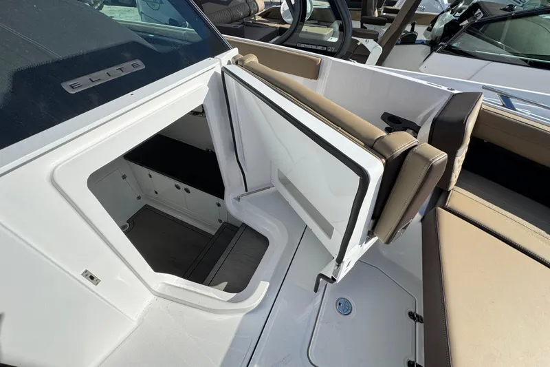 Slide: The Image of 2026 Monterey Elite 27 OB boat interior with open storage compartment and seating. - 11