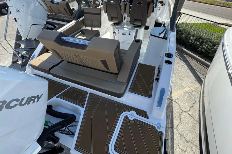 Slide: The Image of 2026 Monterey Elite 27 OB boat interior with seating and Mercury engine. - 3
