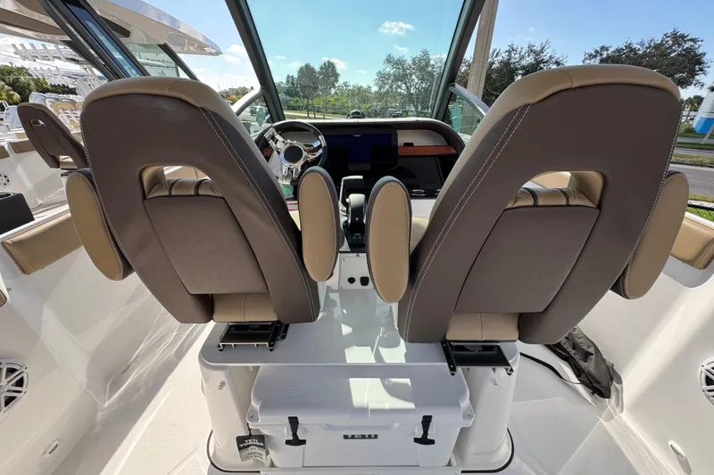 Slide: The Image of 2026 Monterey Elite 27 OB boat interior with dual captain seats and modern dashboard. - 6